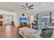 Bright living room featuring hardwood floors, vaulted ceiling, fan, and sliding doors to the patio at 5033 Carrington Ct, Summerville, SC 29485
