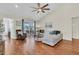 Inviting living room with vaulted ceiling, hardwood floors, and sliding glass doors to patio at 5033 Carrington Ct, Summerville, SC 29485