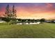 Scenic view of a tranquil pond at sunset, enhancing the property's natural beauty and peaceful setting at 5033 Carrington Ct, Summerville, SC 29485