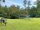 Enjoy the serene pond with a fountain, enhancing the property with natural beauty and tranquil outdoor space at 5033 Carrington Ct, Summerville, SC 29485
