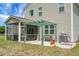 Landscaped backyard featuring a pergola, screened-in porch, and well-maintained lawn at 515 Flycatcher Dr, Goose Creek, SC 29445
