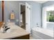 Bright bathroom featuring a double vanity, soaking tub, and a view to the outdoors at 515 Flycatcher Dr, Goose Creek, SC 29445