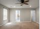 Bright bedroom featuring carpet, neutral walls, a ceiling fan, and multiple doorways for added functionality at 515 Flycatcher Dr, Goose Creek, SC 29445