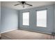 Empty bedroom with light blue walls, two windows and carpeted floors at 515 Flycatcher Dr, Goose Creek, SC 29445