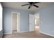 Bedroom with two open closet doors, painted in a light blue color at 515 Flycatcher Dr, Goose Creek, SC 29445