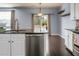Open kitchen layout with a view of the backyard through sliding glass doors, and modern appliances at 515 Flycatcher Dr, Goose Creek, SC 29445