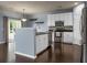 Modern kitchen with stainless steel appliances, granite countertops, and sleek white cabinets at 515 Flycatcher Dr, Goose Creek, SC 29445