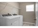 Bright laundry room features a modern washer and dryer, plus convenient overhead shelving at 515 Flycatcher Dr, Goose Creek, SC 29445