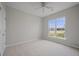 Bright bedroom features a ceiling fan, carpeted floors and a large window at 554 Tranquil Waters Way, Summerville, SC 29486