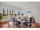 Charming dining room with a view of the yard through multiple windows at 554 Tranquil Waters Way, Summerville, SC 29486