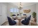 Dining room features a rustic table, woven wall hangings, and views of the yard at 554 Tranquil Waters Way, Summerville, SC 29486
