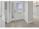 The home features a glass front door with tile flooring and fresh, light-colored paint at 554 Tranquil Waters Way, Summerville, SC 29486