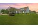 Charming single-story home features a manicured lawn and flowering shrubbery at 554 Tranquil Waters Way, Summerville, SC 29486