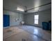 Spacious garage featuring painted concrete floors, a utility sink, and a side window at 554 Tranquil Waters Way, Summerville, SC 29486