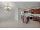 Spacious kitchen features granite counters, dark cabinets and stainless steel appliances at 554 Tranquil Waters Way, Summerville, SC 29486