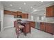 Bright kitchen features granite counters, dark cabinets and stainless steel appliances at 554 Tranquil Waters Way, Summerville, SC 29486