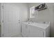 Clean laundry room featuring a side-by-side washer and dryer, and storage shelves at 554 Tranquil Waters Way, Summerville, SC 29486