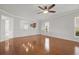 Open living room with hardwood floors and a view of the kitchen bar seating area at 554 Tranquil Waters Way, Summerville, SC 29486