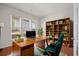 Inviting home office with hardwood floors, built-in bookshelves, and a comfortable workspace at 554 Tranquil Waters Way, Summerville, SC 29486