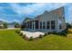 This outdoor patio features a tile base, modern seating, and backyard landscaping at 554 Tranquil Waters Way, Summerville, SC 29486