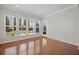 Bright sun room with hardwood floors and multiple windows offering backyard views at 554 Tranquil Waters Way, Summerville, SC 29486