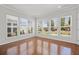 Sun-filled room with hardwood floors, providing ample natural light and outdoor views at 554 Tranquil Waters Way, Summerville, SC 29486
