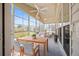 Bright sunroom with ample seating, a dining area, and large windows offering beautiful backyard views at 554 Tranquil Waters Way, Summerville, SC 29486