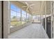 Bright sunroom featuring tile flooring, large windows, and a ceiling fan for comfort at 554 Tranquil Waters Way, Summerville, SC 29486