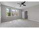 Bright bedroom with large windows and ceiling fan at 5554 Colonial Chatsworth Cir, North Charleston, SC 29418