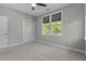 Cozy bedroom features carpet, a window with leafy views, and a closet at 5554 Colonial Chatsworth Cir, North Charleston, SC 29418