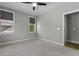 Bedroom with carpet, two windows, ceiling fan, and ensuite door at 5554 Colonial Chatsworth Cir, North Charleston, SC 29418