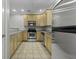 Well-lit kitchen features stainless steel appliances, granite countertops, and light wood cabinets at 5554 Colonial Chatsworth Cir, North Charleston, SC 29418