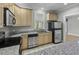 Well-appointed kitchen features stainless appliances, light wood cabinets, and granite countertops at 5554 Colonial Chatsworth Cir, North Charleston, SC 29418