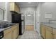 Kitchen features stainless appliances, double sink, light wood cabinets and granite countertops at 5554 Colonial Chatsworth Cir, North Charleston, SC 29418