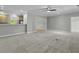 Open-concept living room featuring neutral carpet leading to the kitchen with bar top at 5554 Colonial Chatsworth Cir, North Charleston, SC 29418