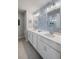 Modern bathroom with double vanity, framed mirrors, and floral wallpaper at 571 Mclernon, Johns Island, SC 29455
