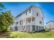 Charming raised beach home featuring a ground-level patio and a quaint second-story balcony at 571 Mclernon, Johns Island, SC 29455