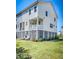 Exterior view of the home showcasing the well-manicured lawn and covered porch at 571 Mclernon, Johns Island, SC 29455