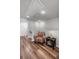 Bright hallway with wood floors features an accent chair and stairway access at 571 Mclernon, Johns Island, SC 29455
