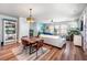 Open-concept living room featuring a rustic dining table and a comfortable seating arrangement at 571 Mclernon, Johns Island, SC 29455