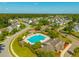 Wide aerial shot showcasing sparkling community pool, clubhouse, and lush landscaping in a desirable neighborhood at 7601 Stargazer Dr, Hanahan, SC 29410