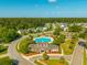 Stunning aerial view featuring community pool, clubhouse and landscaped common areas, surrounded by lush greenery at 7601 Stargazer Dr, Hanahan, SC 29410