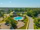 Community aerial showcasing neighborhood pool, clubhouse, playground, and surrounding homes and trees at 7601 Stargazer Dr, Hanahan, SC 29410