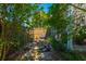 Secluded backyard garden area with stone path, bench, and lush landscaping, offering a tranquil retreat at 7601 Stargazer Dr, Hanahan, SC 29410