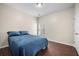 Cozy bedroom features a comfortable bed and warm, inviting decor, with hardwood floors and a bright window at 7601 Stargazer Dr, Hanahan, SC 29410
