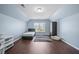 Attic bedroom with blue walls, hardwood floors, window view, and storage furniture, great for flexible space at 7601 Stargazer Dr, Hanahan, SC 29410