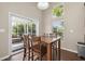 Cozy dining area with wood table, chairs, large window and screened porch access at 7601 Stargazer Dr, Hanahan, SC 29410
