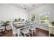 Bright dining area featuring a chandelier, hardwood flooring, and windows at 7601 Stargazer Dr, Hanahan, SC 29410