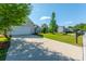 A charming home featuring a two-car garage, beautifully maintained lawn and landscaping on a sunny day at 7601 Stargazer Dr, Hanahan, SC 29410