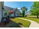 Charming home with a well-manicured lawn, blooming flowers, and a welcoming walkway under a bright blue sky at 7601 Stargazer Dr, Hanahan, SC 29410